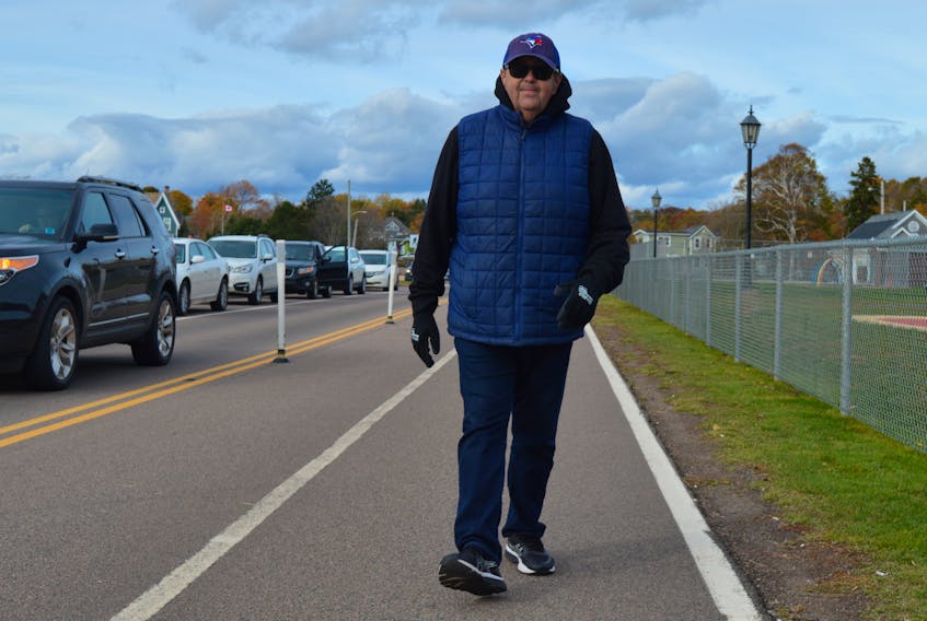 Davis Ward of Stratford enjoys a brisk walk on the paved active transportation path along Victoria Park in Charlottetown on Thursday. The path, also referred to as the bike lane, will close for the season on Sunday and reopen to vehicular traffic on Monday.