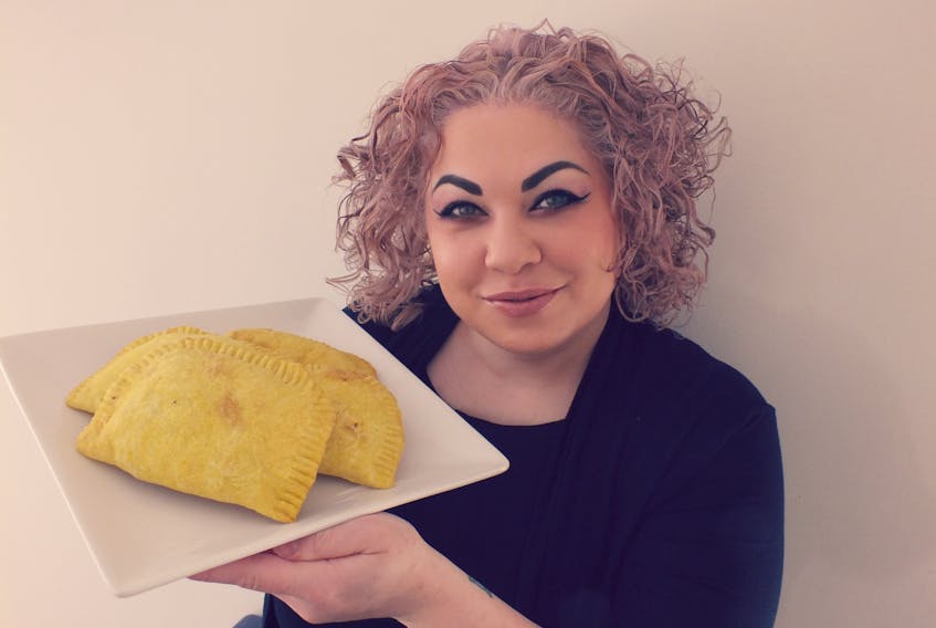 Chef Ilona Daniel shows a plate of her Jamaican-style beef patties. 