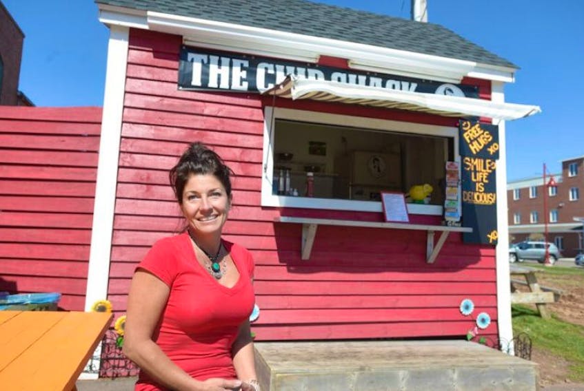 <p>&nbsp;Caron Prins sits at a table in front of her chip shack near Founder's Hall. If several nearby restuarant operators have their way Charlottetown city council will deny Prins a permit to operate her chip shack this summer. Council has voted not to issue her a permit to operate this summer based on several comnplaints. Guardian photo by Brian McInnis</p>