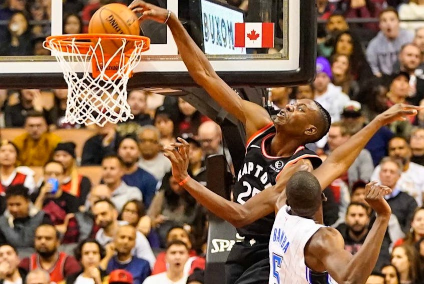 Raptors forward Chris Boucher (25) dunks the ball against Magic centre Mo Bamba (5) during NBA action at Scotiabank Arena in Toronto, on Wednesday, Nov. 20, 2019.