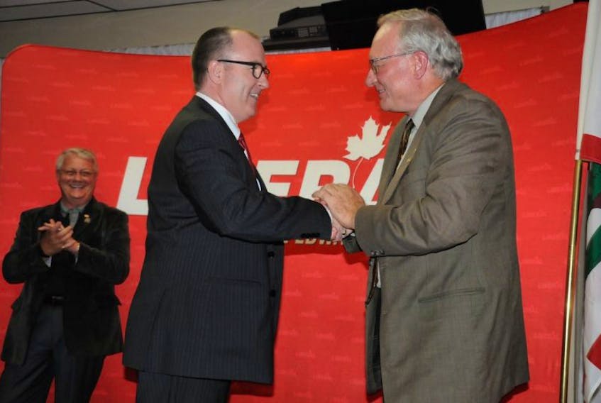 Chris Palmer, right, shakes hands with Premier Wade MacLauchlan after being elected the Liberal party's nominee for the District 21, Summerside-Wilmot, byelection.&nbsp;