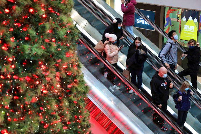 Shoppers wearing mandatory masks pass Christmas Tree, two days before coronavirus disease (COVID-19) restrictions are reintroduced to Greater Toronto Area regions, at Eaton Centre mall in downtown Toronto, Ontario, Canada November 21, 2020.  