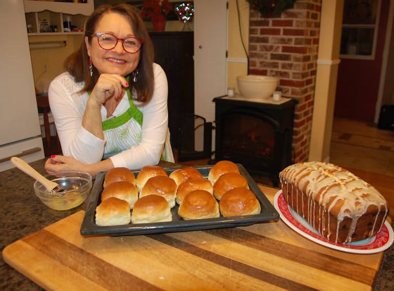 Professional baker Glenda Landry, posing with her fresh creations of Christmas cranberry loaf and Acadian-styled raised biscuits called Galette Blanche, says the lock-down on P.E.I. in March and April saw many Islanders getting back into baking - or trying their hand at the culinary craft for the first time.