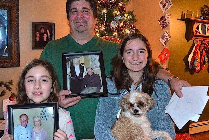 Mark Enman and his daughters Hayley (left) and Carly hold pictures of Bev and Don during happier times. The family is hoping for a Christmas miracle and is hoping the public can help.