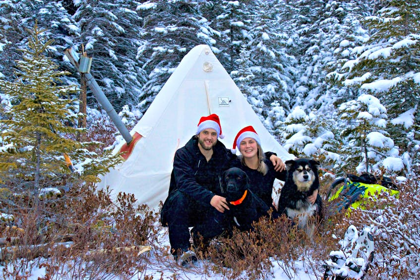 Justin Barbour with his fiancée Heather Oakley and their two dogs, Saku and Bear. Unplugging and reconnecting with nature in the Newfoundland wilderness tops the Christmas gift list for this couple. 