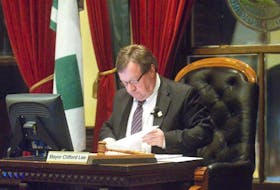 Charlottetown Mayor Clifford Lee looks over some paperwork during the regular meeting of city council Monday night.