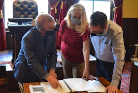 Charlottetown Mayor Philip Brown goes over the 2021-22 capital budget on Monday with Connie McGaugh, accounting clerical clerk; and Stephen Wedlock, controller for the city.
