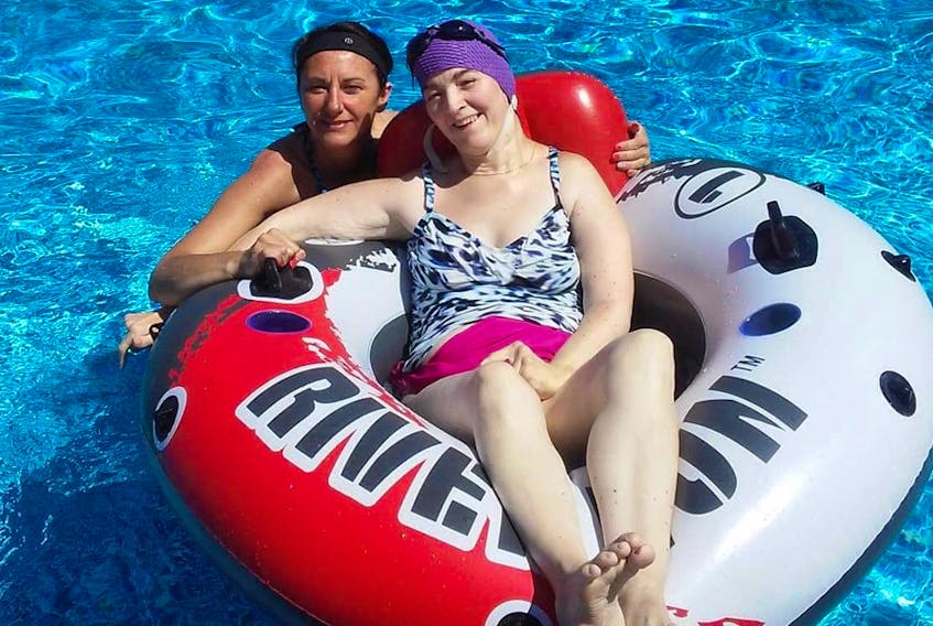 Carla White (in float) and her homecare worker, Brenda Morgan, cool off in the water.