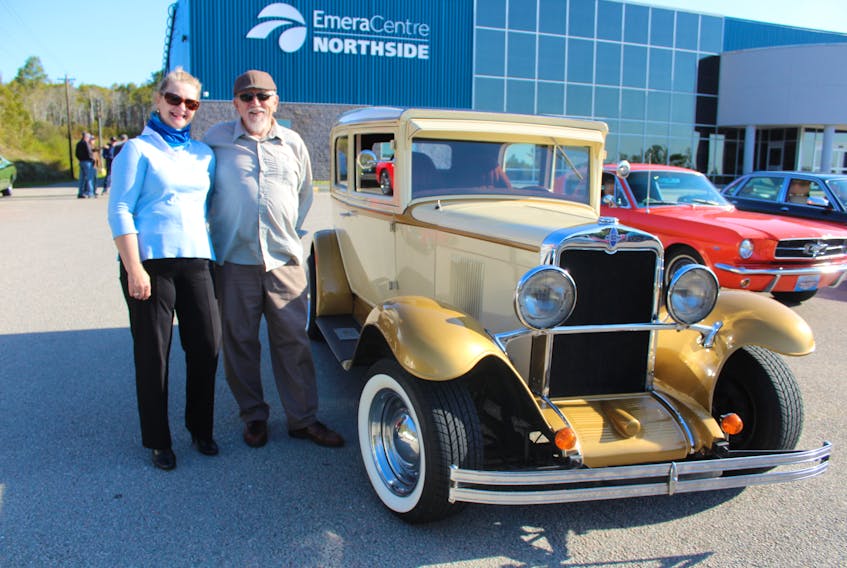 Classic car enthusiasts Joanne and Gary Knoblett stand next to Gary's 1930 Chevrolet, which he's had for the last 23 years. Joanne has two Mustangs and says they have a "mixed marriage of Mustangs and Chevys." The Glace Bay couple drove in the car parade with hopes it would bring "smiles to their faces," for both staff and residents of nursing homes. NICOLE SULLIVAN/CAPE BRETON POST