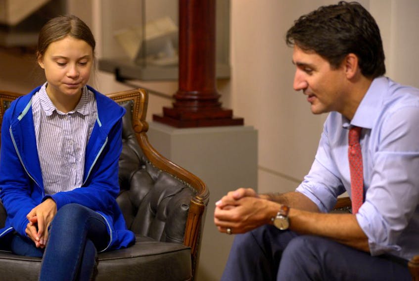 Prime Minister Justin Trudeau, right, sits down with Swedish climate change activist Greta Thunberg, in Montreal, in 2019.