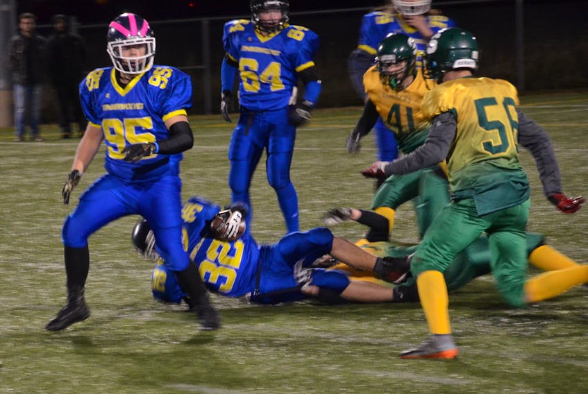 The Summerside Clippers' defence tackles the Cornwall Timberwolves' Christian Desreux, 32, during Friday night's P.E.I. Varsity Tackle Football League game at Eric Johnston Field. The Clippers won the contest 28-14.