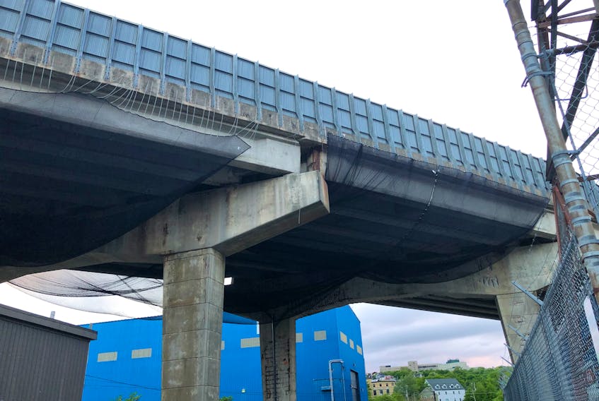 Black netting has been installed underneath the deteriorating CN viaduct on Pitts Memorial Drive to catch any concrete that might come loose. -JUANITA MERCER/THE TELEGRAM