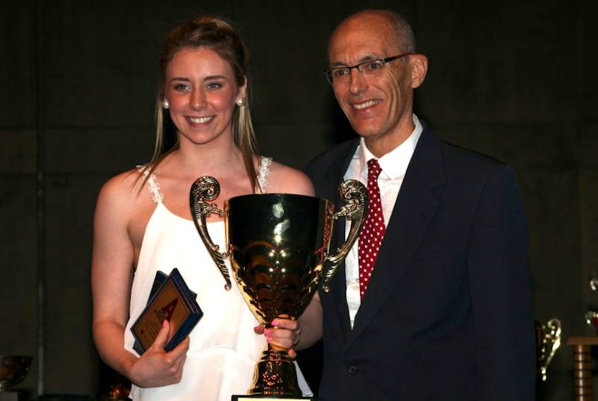 Acadia interim swimming head coach David Fry presents Rebecca MacPherson with Acadia's Female Swimmer of the Year award at the 2014-2015 varsity athletic awards earlier this year. Fry passed away Oct. 22 after a battle with cancer. <br /><br /> 