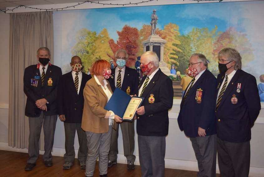 Cumberland-Colchester MP Lenore Zann presents the emergency support fund to Truro Colchester Legion president Terry Flewelling. The legion was one of seven in the riding to receive the fund. In the back, from left to right: Gerry Hall, Charles Borden Jr., Gregg Dill, Marc Osmond and Chris Donnaiche. 