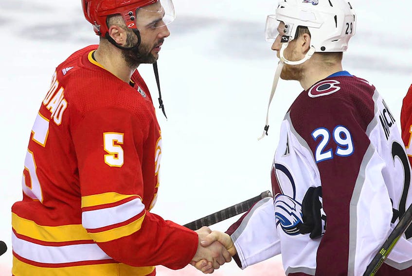 Flames Mark Giordano (L) shakes hands with Avalanche Nathan MacKinnon following game five between the Colorado Avalanche and Calgary Flames in Calgary on Friday, April 19, 2019. Flames lost 5-1. 