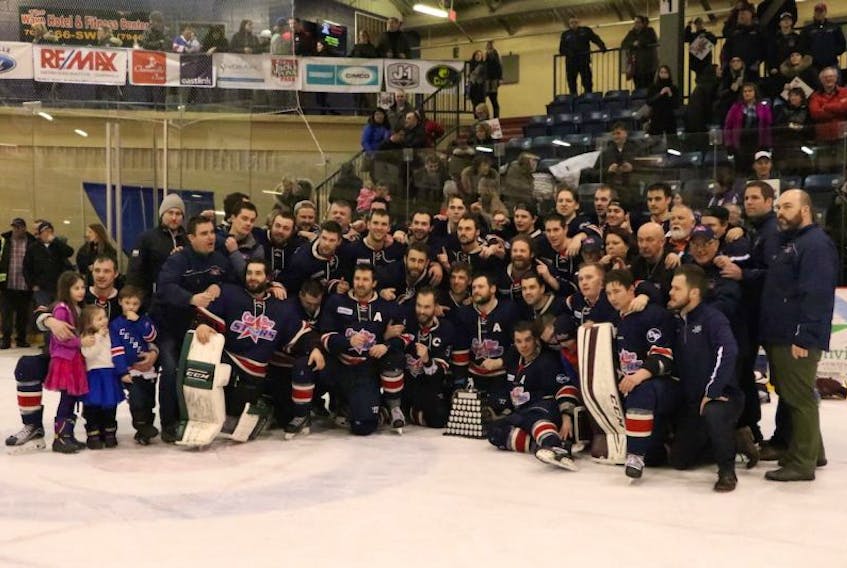 In this April 2, 2017 file photo, members of the Harbour Grace Ocean Enterprises CeeBee Stars gather around the Herder Memorial Trophy following a deciding 4-3 victory over the CWSHL champion Clarenville Caribous in Game 5 of the provincial senior hockey championship in Clarenville. Less than six months after been winning the Herder, the Avalon East senior league champion CeeBees have been told by the other four AESHL teams they are no longer wanted in the league.