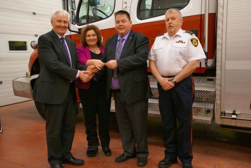 Minister of Municipal Affairs and Environment Eddie Joyce, left, and Placentia-St. Mary’s MHA Sherry Gambin-Walsh presented the truck’s keys to Placentia Mayor Wayne Power Jr. and Placentia Fire Chief Wayne Power Sr. during a ceremony at the fire station March 1.
