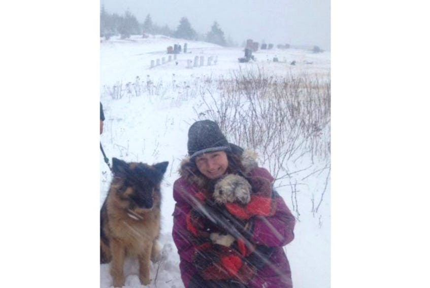 Lindsay Parsons gives her Shih Tzu, Odie, a hug after finding him Tuesday in the middle of a snowstorm. A group effort lead to Odie’s rescue.