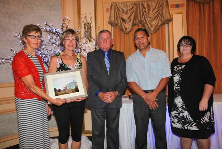 <div>
<div>Charlottetown Deputy Mayor Mike Duffy presents the Mayor’s Award to representatives of Park Royal United Church at the Make Charlottetown Bloom Awards Ceremony on Thursday evening (September 8). From Left: Shelley MacEwen and Donna Carr from Park Royal United Church; City of Charlottetown Deputy Mayor Mike Duffy; and Home Hardware Charlottetown representatives Les Wong and Tammy Clory. The local beautification program, in association with the national Communities in Bloom program, is designed to reward those who maintain buildings and landscapes within City limits. Businesses and residents can enter themselves or nominate someone else.</div>
<div>&nbsp;</div>
</div>