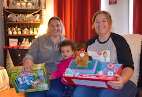 Annapolis Valley Frugal Moms – Helping Hands co-ordinator Jodi Bishop, Annapolis Valley Frugal Moms Society president and co-creator Lisa Rose and Rose’s daughter, Jamelia, with some donated toys that will brighten Christmas morning for families in need. KIRK STARRATT