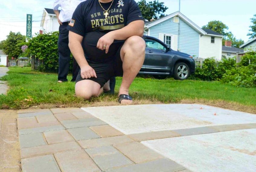 <span class="Normal">Shadi Sahely and his father Norman, in the background, say they feel bad for everyone in the greater Charlottetown area dealing with have a community mailbox located on or adjacent to their property. Contractors laid a concrete base on a property Norman rents out at the corner of Bungalow and Century streets in Charlottetown.</span>