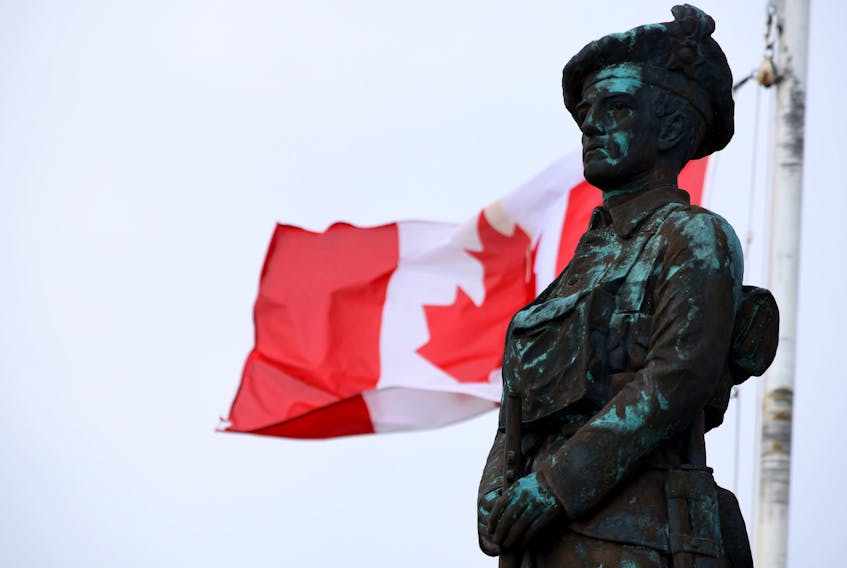 The Canadian flag flies behind the statue on top of the cenotaph in Clark's Harbour. Kathy Johnson