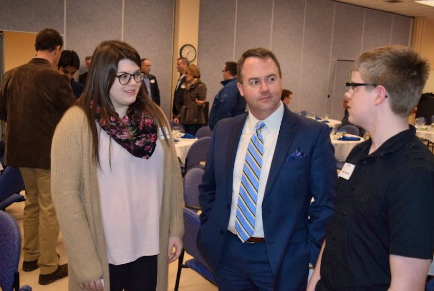 Jessie Colborne, a Grade 11 student at CEC and Sebastien Martell, a Grade 11 student at North Colchester, talk with Mike Johnston, CEO of Red Space, an IT firm in Bedford, after Johnston’s presentation to the Truro and Colchester Chamber of Commerce Feb. 23.