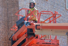 Jeff Trowsdale works on a new apartment building going up in Charlottetown to replace the three-storey complex that was destroyed in a fire last year. Although quarantine restrictions have impacted P.E.I.’s construction industry, many builders say they have not received direct workplace safety guidance from public health.
