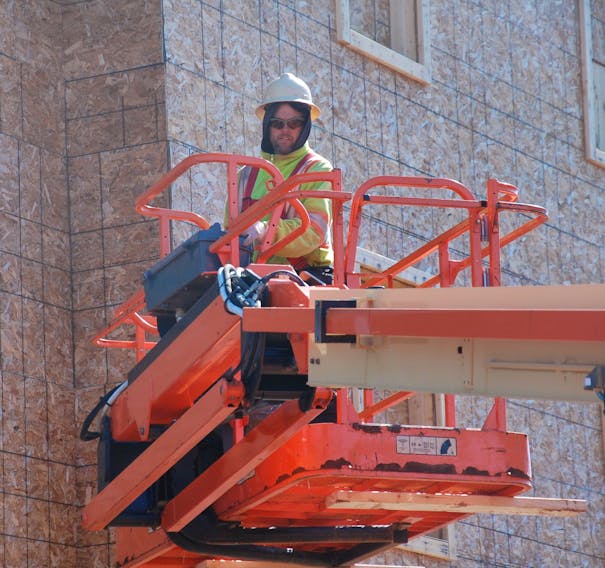 Jeff Trowsdale works on a new apartment building going up in Charlottetown to replace the three-storey complex that was destroyed in a fire last year. Although quarantine restrictions have impacted P.E.I.’s construction industry, many builders say they have not received direct workplace safety guidance from public health.