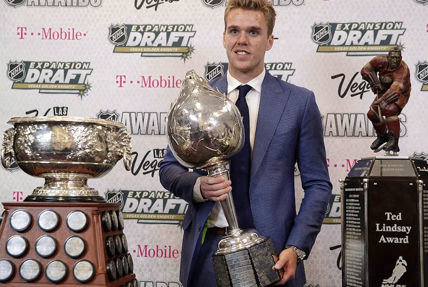 Connor McDavid of the Edmonton Oilers poses with the Art Ross Trophy, left, the Hart Memorial Trophy, centre, and the Ted Lindsay Award after winning the honours during the NHL awards ceremony on June 21, 2017, in Las Vegas.