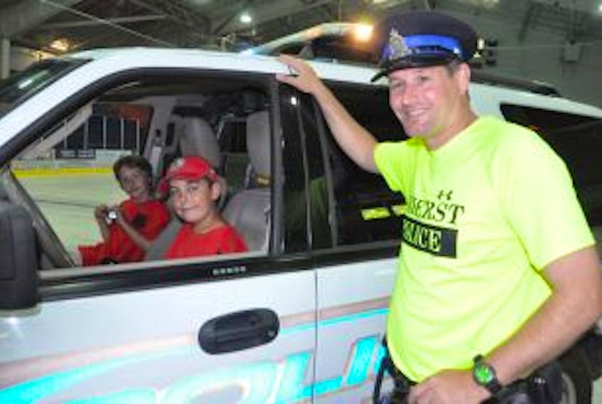 ['<p>Dallas Hunter (left) and Mason Porter were two of the local young people taking part in the Cops for Kids camp this summer, and had the opportunity to familiarize themselves with the emergency police vehicle with Const. Tom Wood.</p>']