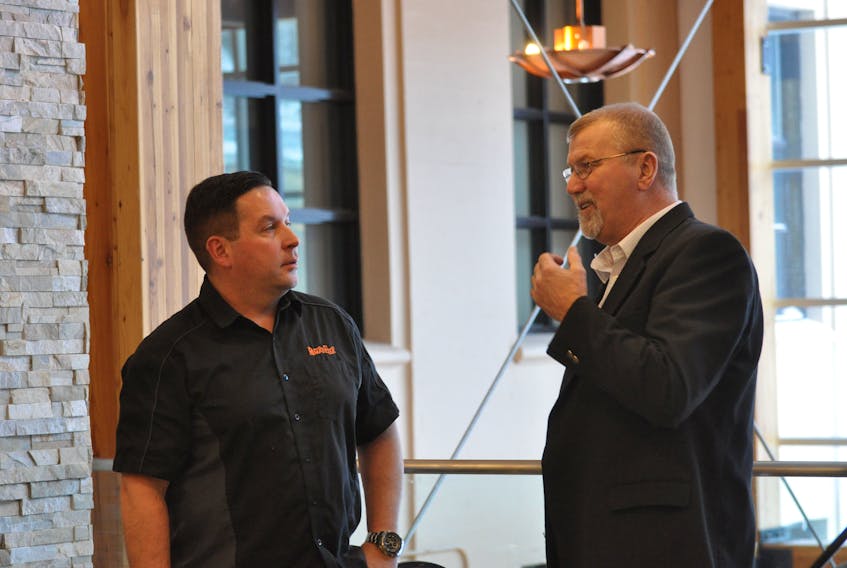 Craig Borden, left, and Coun. Tony Buckle chat at the announcement for Corner Brook’s new Jigs and Wheels Festival at city hall Wednesday. Borden’s business, Rugged Edge, is one of the event's sponsors. - Diane Crocker/The Western Star