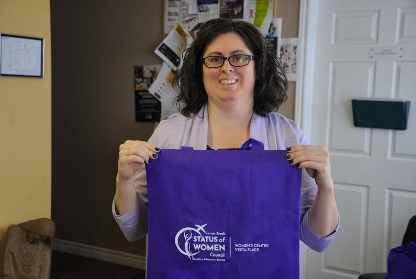 The Corner Brook Status of Women Council office recently celebrated its 45th anniversary with an open house to show appreciation to its partners, volunteers and staff and to unveil a new logo designed by local artist Ed Hollett. Research coordinator Melissa Feaver shows off a shopping bag, just one piece of council merchandise featuring the new logo. Other items include pens, credit card holders and windshield scrapers. The council, which is located at 2 Carmen Ave., was established in 1974 to advocate gender equality and equity in the community and to provide accompanying education and resources. STEPHEN ROBERTS/THE WESTERN STAR