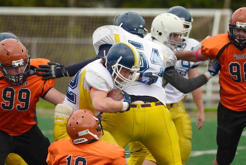 Spencer Younker of the Cornwall Timberwolves breaks a tackle by the Amherst Wolfpack during action Sunday in Cornwall in the P.E.I Tackle Football League. The team praised the defensive line of David MacKenzie, Matt Jack and Tyson Carter, calling it the "heartbeat of the team."