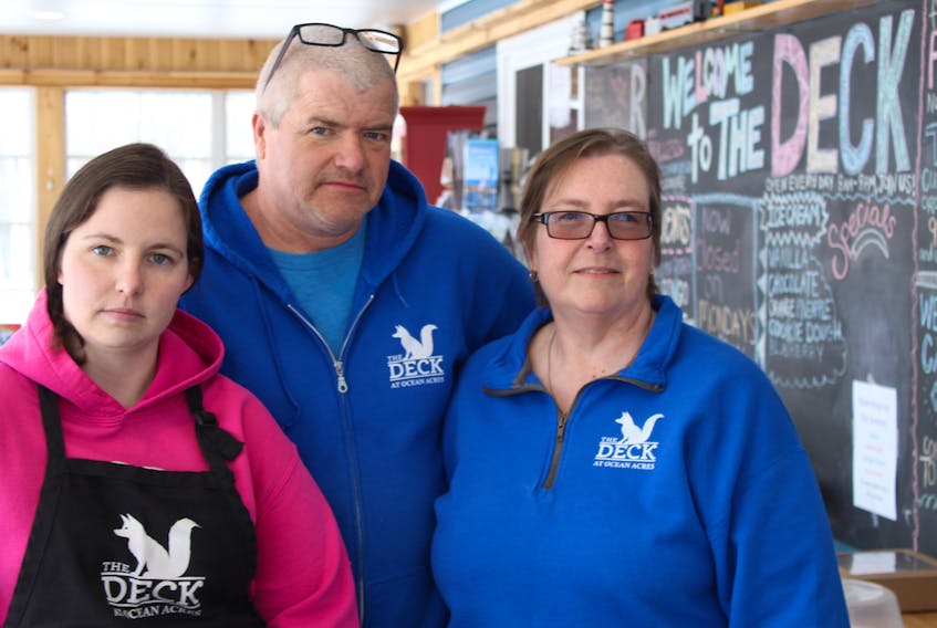 Leslie Swift, left, and her parents, Tim and Sharon, stand in the dining area of their restaurant, The Deck, in Murray Harbour on March 31.