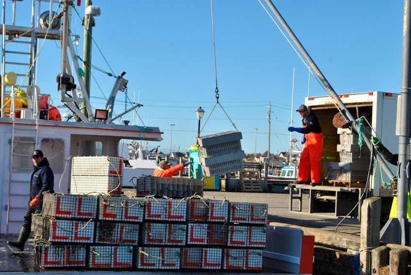 Crates of lobsters are offloaded from the Lady Laura at the Clark’s Harbour wharf on Wednesday. The sudden and unexpected temporary loss of the Chinese market for Nova Scotia live lobsters due to the coronavirus epidemic has sent the shore price plummeting from $10.50 to $8 a pound, creating a panic situation for the lobster industry. KATHY JOHNSON PHOTO

