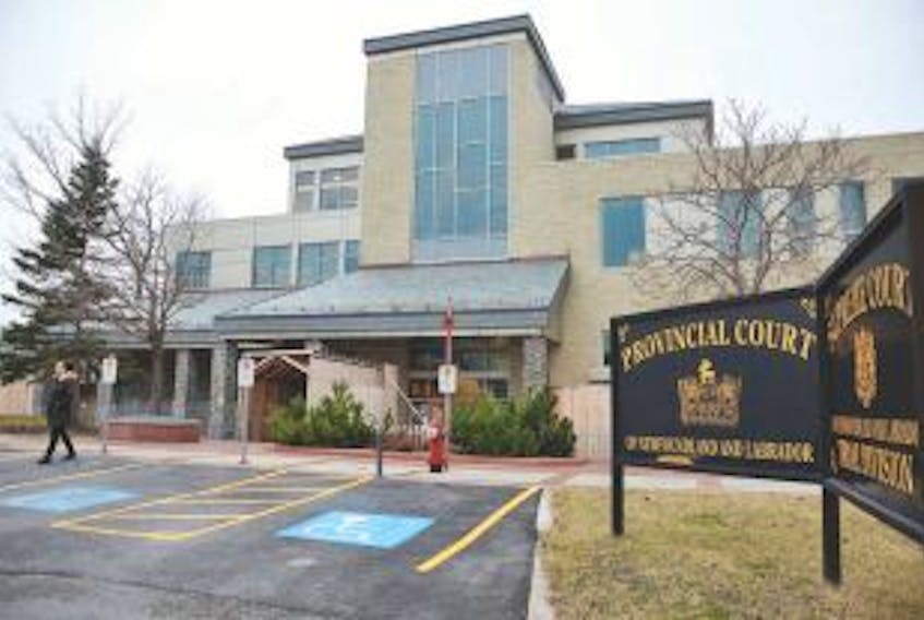 ['Safety fencing is still around the Corner Brook Law Courts as the provincial government tries to work with the contractor that designed and installed the roof.']