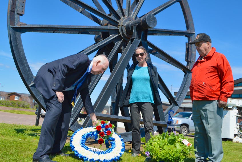Cape Breton Regional Municipality District 9 Coun. George MacDonald, left, lays a wreath at the Miners’ Memorial Park in Glace Bay, accompanied by Mary Pat Mombourquette, executive director of the Cape Breton Miners’ Museum, and Dan Jimmy White of Glace Bay, a 28-year former miner, to commemorate William Davis Day. The annual ceremonies were cancelled this year due to the COVID-19 pandemic. Sharon Montgomery-Dupe/Cape Breton Post