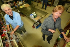 Charlotte Ross, left, and Christine Davis restocked shelves at the Amherst Food Bank. COVID-19 has changed the way people pick up and drop food off at the food bank. File Photo
