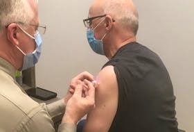 Health Minister Dr. John Haggie posted this picture of himself getting a flu shot from a Gander pharmacist last month. (Twitter)