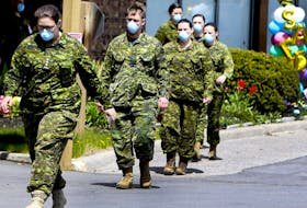 Members of the Canadian Armed Forces in front of Pickering's Orchard Villa long-term care home.