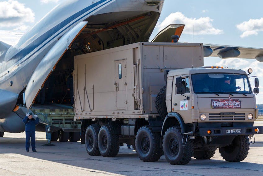  Russian servicemen load medical equipment and special disinfection vehicles into cargo planes while sending the supply to Italy, hit by the outbreak of coronavirus disease (COVID-19), at a military airdrome in Moscow region, Russia March 22, 2020.