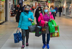 Nancy Mailman, left, and Carol Keough, right, stroll through the Mayflower Mall on Sunday after picking up a few Boxing Day sale items. DAVID JALA/CAPE BRETON POST
