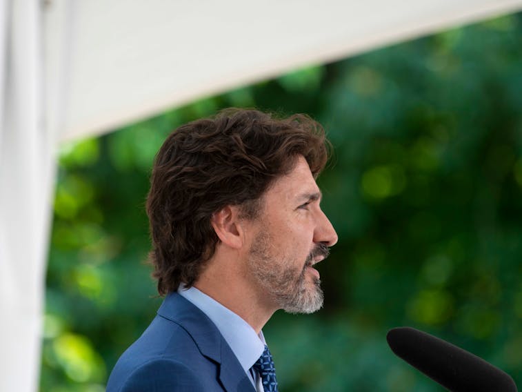 Prime Minister Justin Trudeau responds to a reporter's question during a news conference outside Rideau Cottage in Ottawa, after announcing a program aimed at encouraging students to volunteer, on June 22.