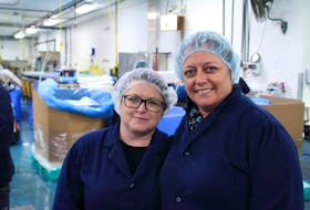 Gail Rose and Letsie Blackmore work at the Cooke Aquaculture processing plant in Hermitage, NL.