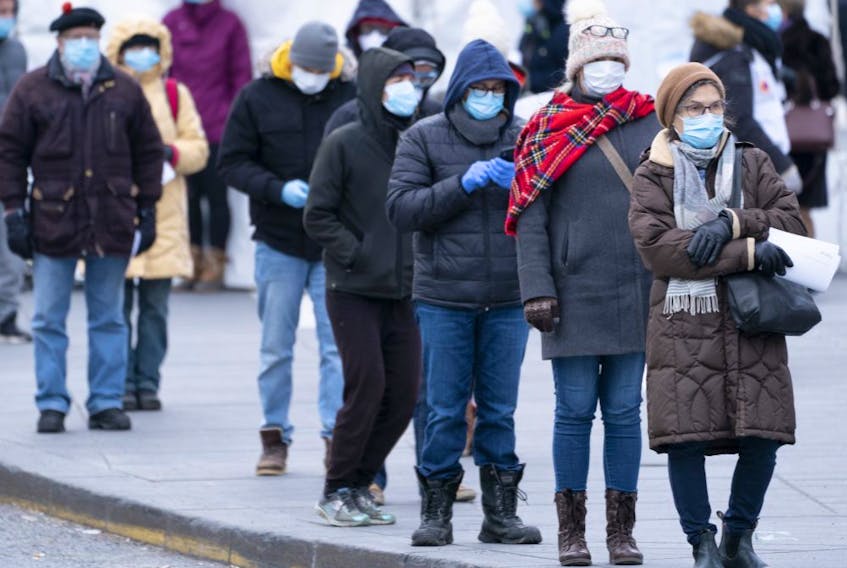  People line up outside a walk-in COVID-19 test clinic in Montreal on Monday, March 23, 2020.
