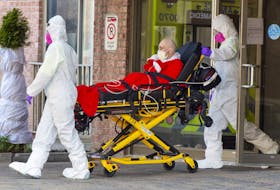 First responders transport a resident of a seniors home to hospital, Tuesday, March 31, 2020 in Montreal.