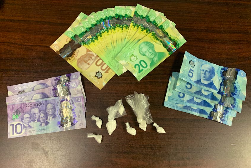 Cash and crack cocaine seized from a man who was found intoxicated on the back deck of an RCMP officer's home.