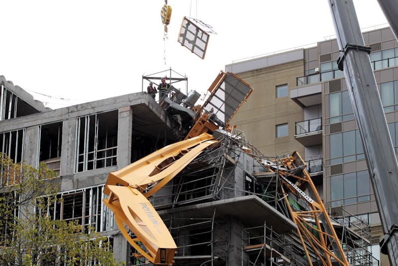 The first piece of the collapsed crane in Halifax is lowered to the ground during its removal. - Tim Krochak
