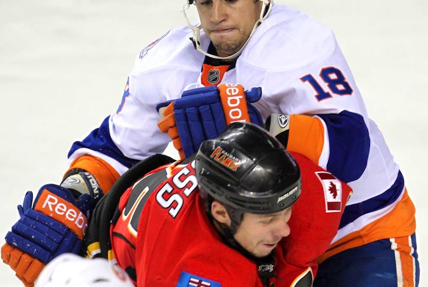 "My role is similar to every team I've been on: A fourth-line guy that makes sure the other team stays honest," said Haley. – Calgary Flames David Moss takes a hit from Micheal Haley of the NY Islanders, September 27, 2011. 